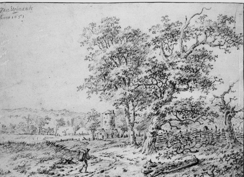 Weg door de velden en huisje met zware toren