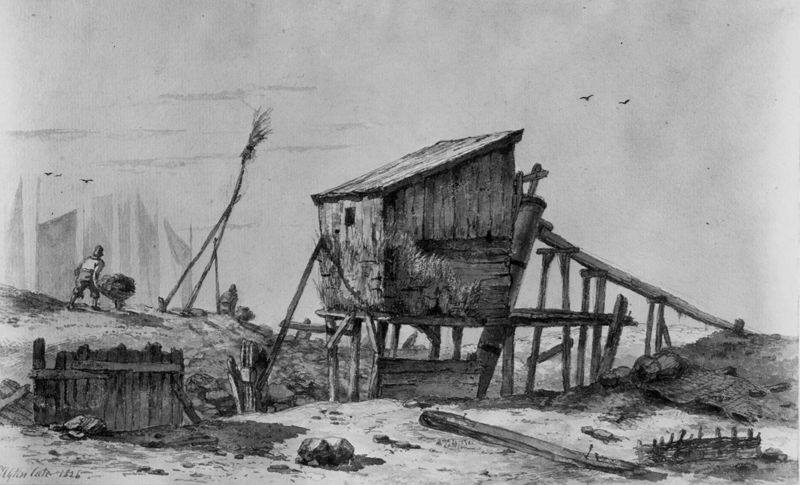 Houten paalhuisje aan het water